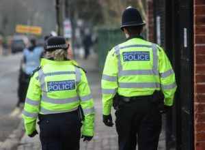 Metropolitan Police officers walking a beat on patrol in Fulham, London