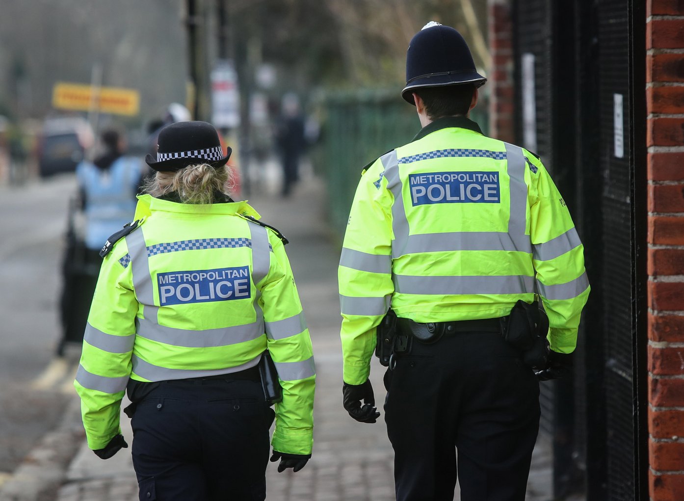 Two Metropolitan Police officers walk on patrol in Fulham, London
