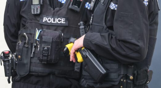 Two uniformed police officers wearing Reveal Media body cameras