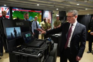 Britain's Prime Minister Keir Starmer tours Palantir Technologies headquarters with company employees and British military personnel Thursday, Feb. 27, 2025, in Washington. (Carl Court/Pool Photo via AP)
