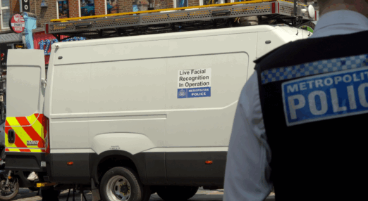 A Metropolitan Police facial recognition van with a sign reading: "Live facial recognition in operation"