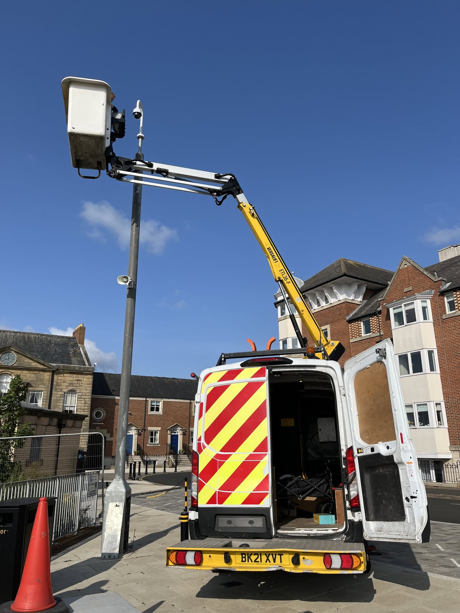 An image of a van with someone in a cherry picker installing AI CCTV cameras on a lamppost in North Tyneside